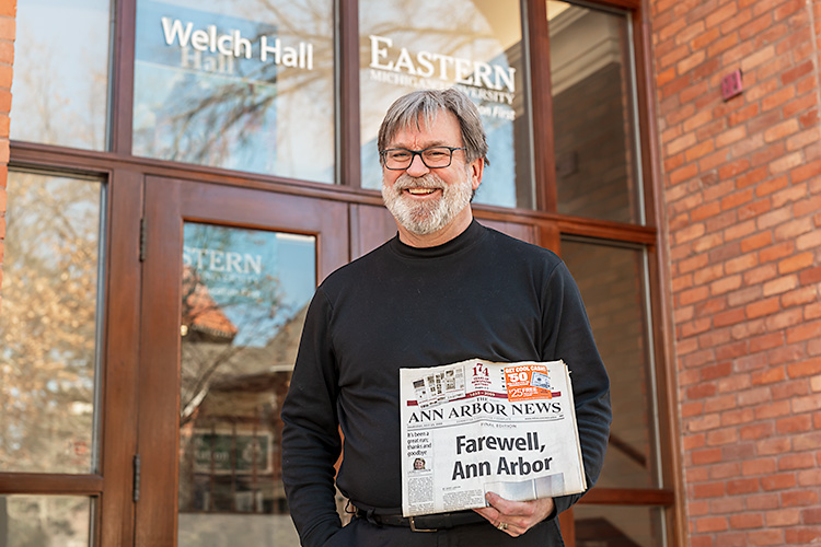 Former Ann Arbor News staffer Geoff Larcom with the last print copy of the Ann Arbor News