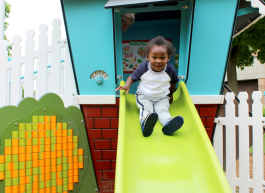A child uses the slide at the new playscape.