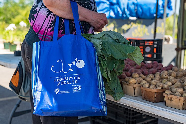 A client using a Prescription For Health tote bag at the Pittsfield Township Farmers Market.
