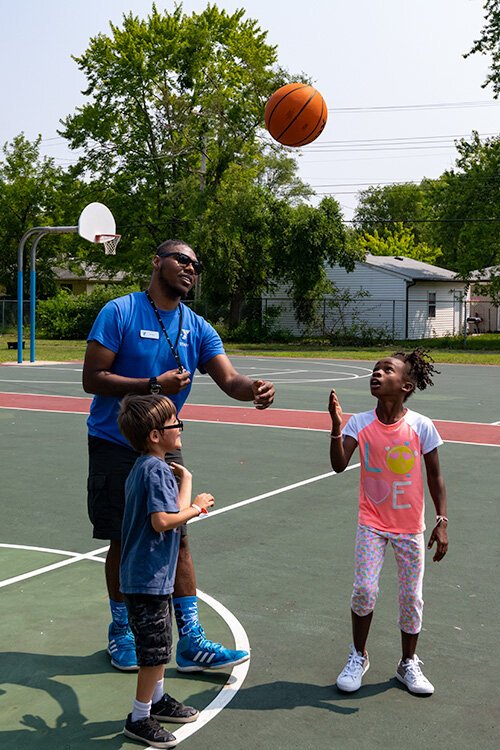 A game of basketball during Y on the Fly in West Willow Park.