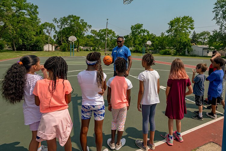 A game of basketball during Y on the Fly in West Willow Park.