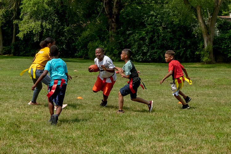 A game of touch football during Y on the Fly in West Willow Park.