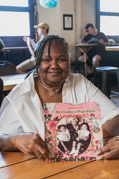 Cheryl Garnett with her children's book about her grandmother.