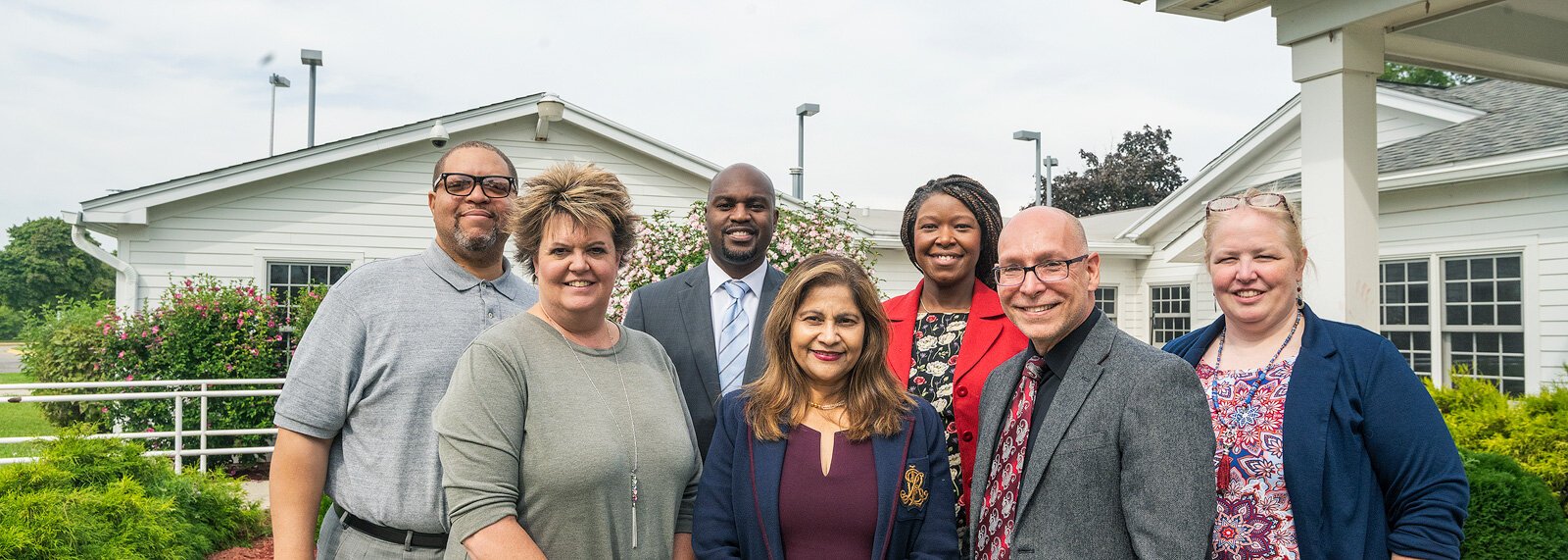 Steven Elam, Ginelle Skinner, Gregory Anglin, Mumtaz Haque, Alena Zachery-Ross, Carlos Lopez, and Nina Harris at YCS Administration Building.