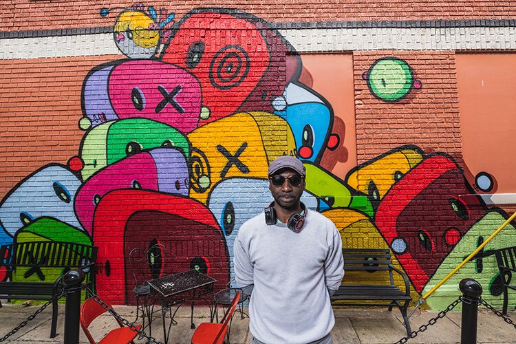 Gary Horton in front of his mural at Go! Ice Cream in Ypsilanti.