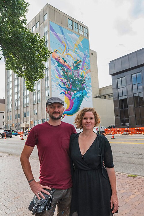 Danijel Matanic and Mary Thiefels of TreeTown Murals in front of their mural at Courthouse Square.