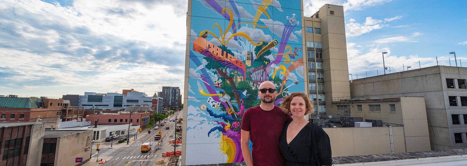 Danijel Matanic and Mary Thiefels of TreeTown Murals in front of their mural at Courthouse Square.