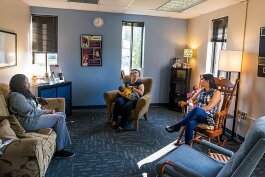 Dera Williams, Najma Treadwell with son Jahleel, and Gayathri Akella at the breastfeeding lounge at the Washtenaw County WIC office.