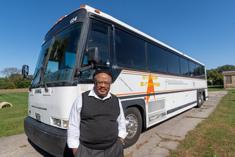 Pastor Robert L. Ford with one of Greater Faith Transition Center's buses.