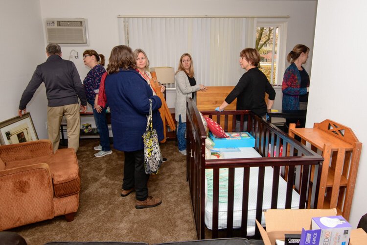 House N2 Home volunteers furnishing Britanni Brooks' apartment.