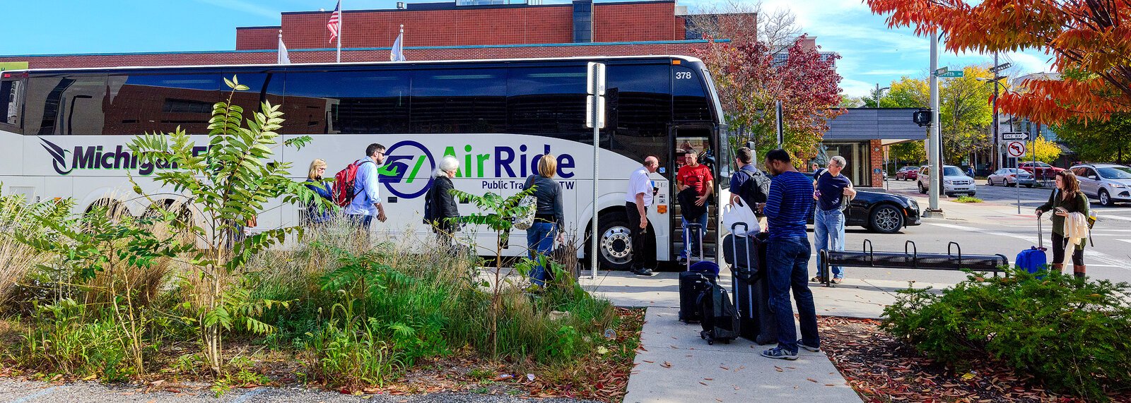 A Michigan Flyer operated shuttle picking up passengers at the Blake Transit Center.