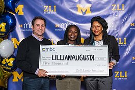 Lillian Augusta founders Nana Britwum (center) and Jannice Newsom (right) accept an award at the Michigan Business Challenge.