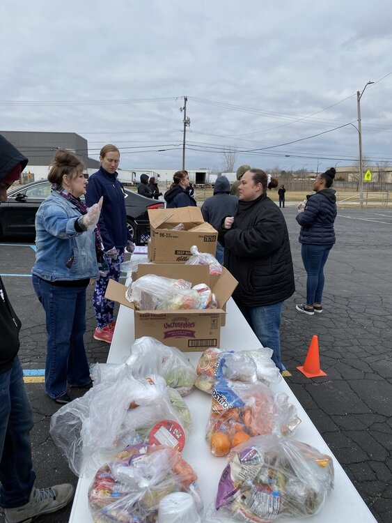 Volunteers are distributing meals to YCS families.