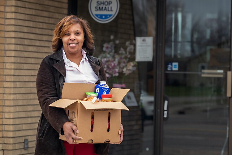 Khadija Wallace hands out meals at Joyful Treats Community Development.