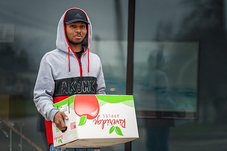 Patrick Cheatham hands out meals at Joyful Treats Community Development.