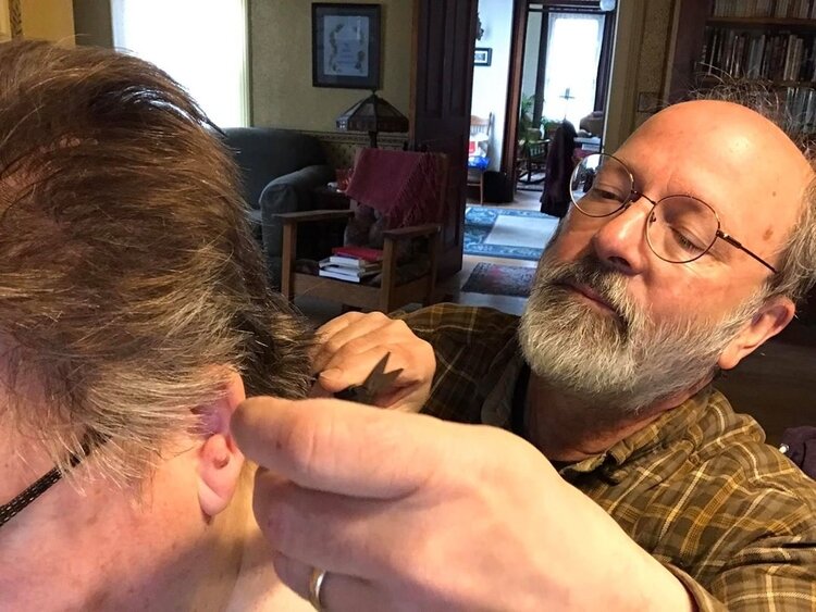 Ypsilanti Coronavirus Digital Archive creator Kim Clarke's husband gives her a home haircut.