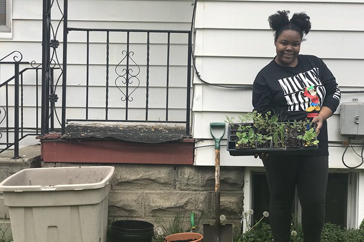 Growing Hope client Teria Moore-Berry recently received several containers for gardening.