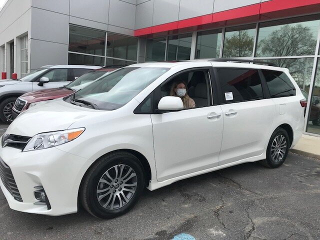 A representative of SOS Community Services picks up their new vehicle.