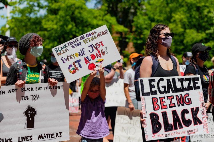 Protestors listen to speakers on the Diag.