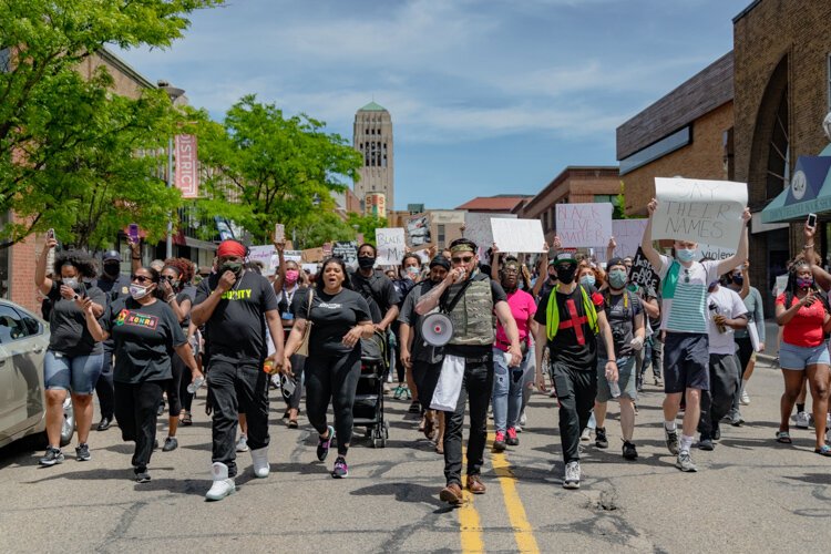 Protestors march through downtown Ann Arbor.