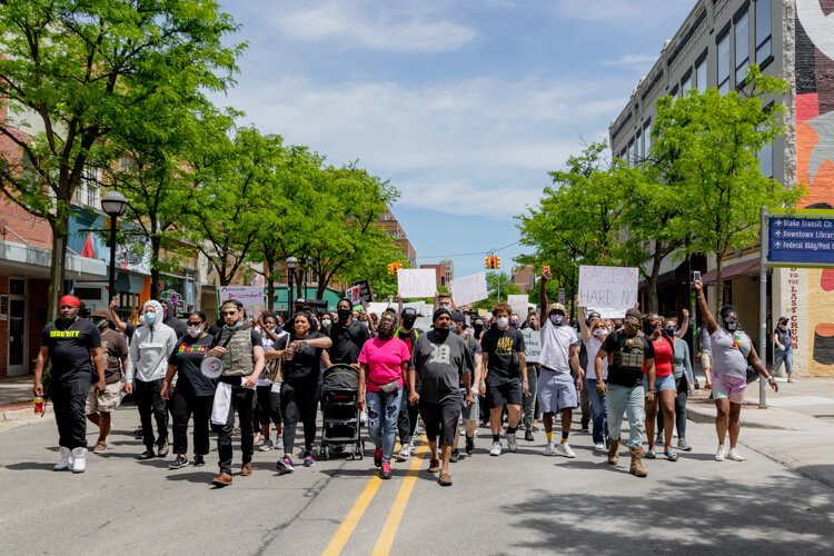 Protestors march through downtown Ann Arbor.