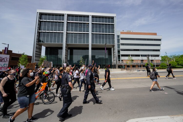 Protestors approach the Ann Arbor Municipal Center.