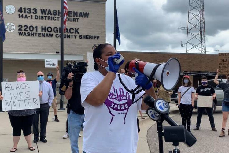 Trische' Duckworth addresses the crowd at a protest at the Washtenaw County Sheriff's office.