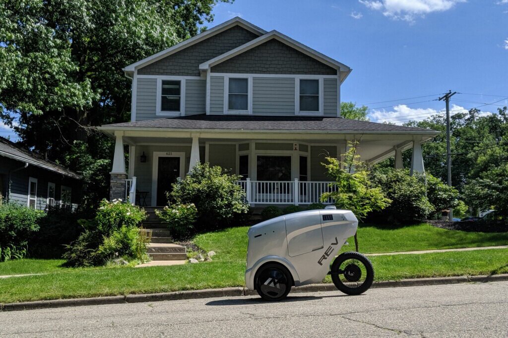 A Refraction AI REV-1 robot makes a delivery.