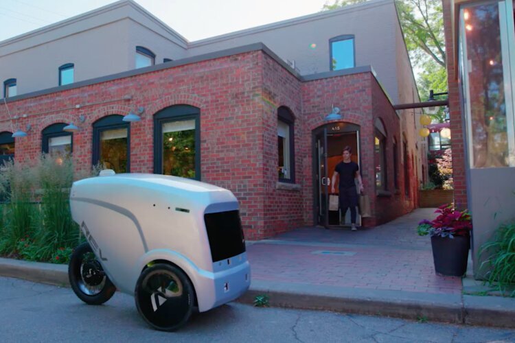 A Refraction AI REV-1 robot picks up a delivery at Miss Kim restaurant in Ann Arbor.