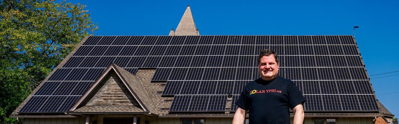 Steve Pierce stands in front of the solar roof at The YPSI.