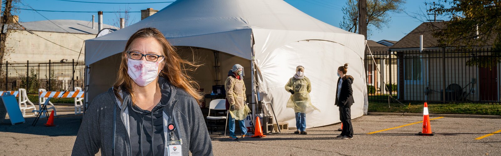 Susan Ringler-Cerniglia, Washtenaw County Health Department communications representative, works a walk-up/drive-through flu vaccine event at the health department's parking lot in Ypsilanti.