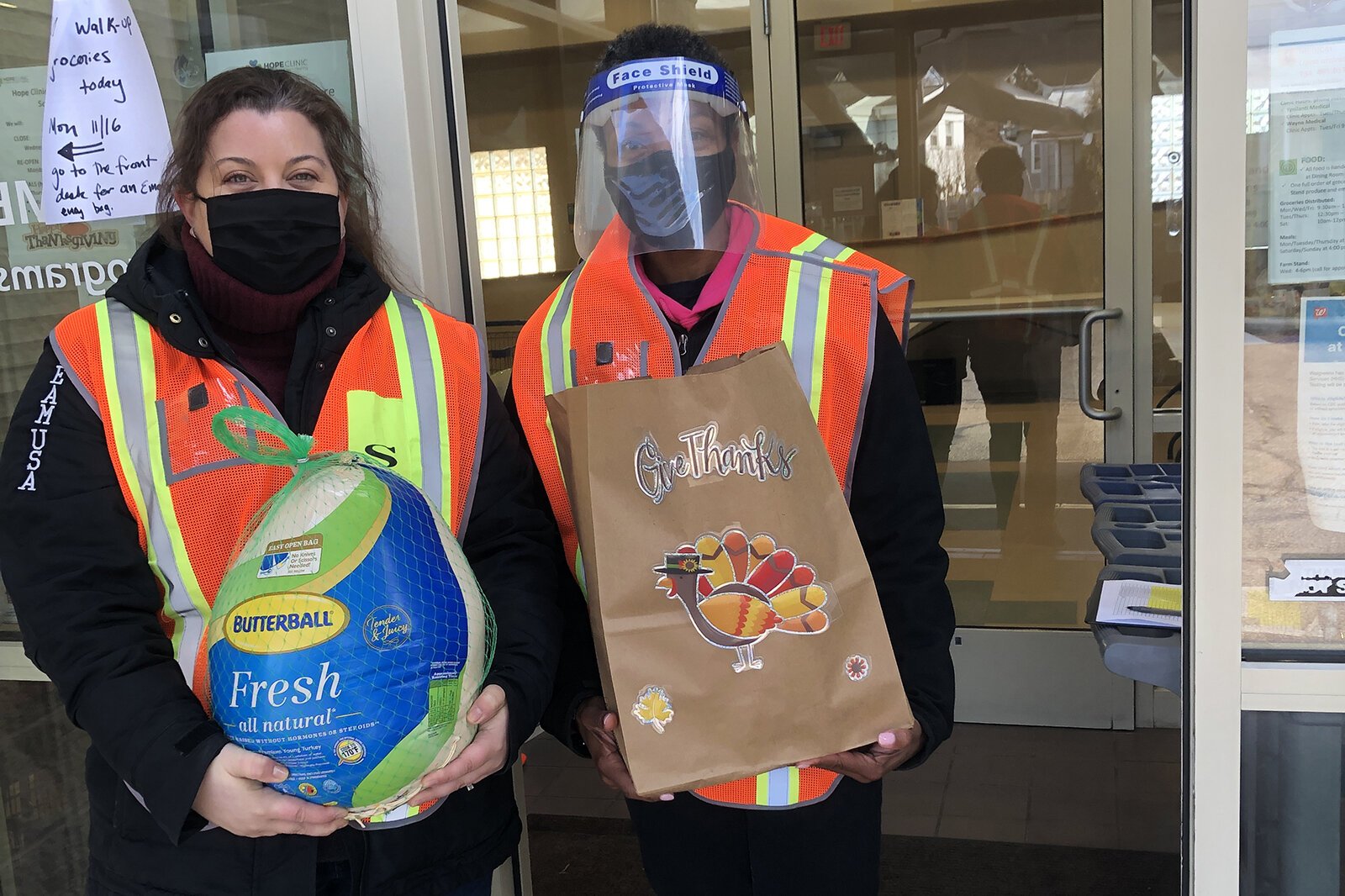 Hope Clinic staff hand out turkeys and bags of fixings to those who have signed up for them.