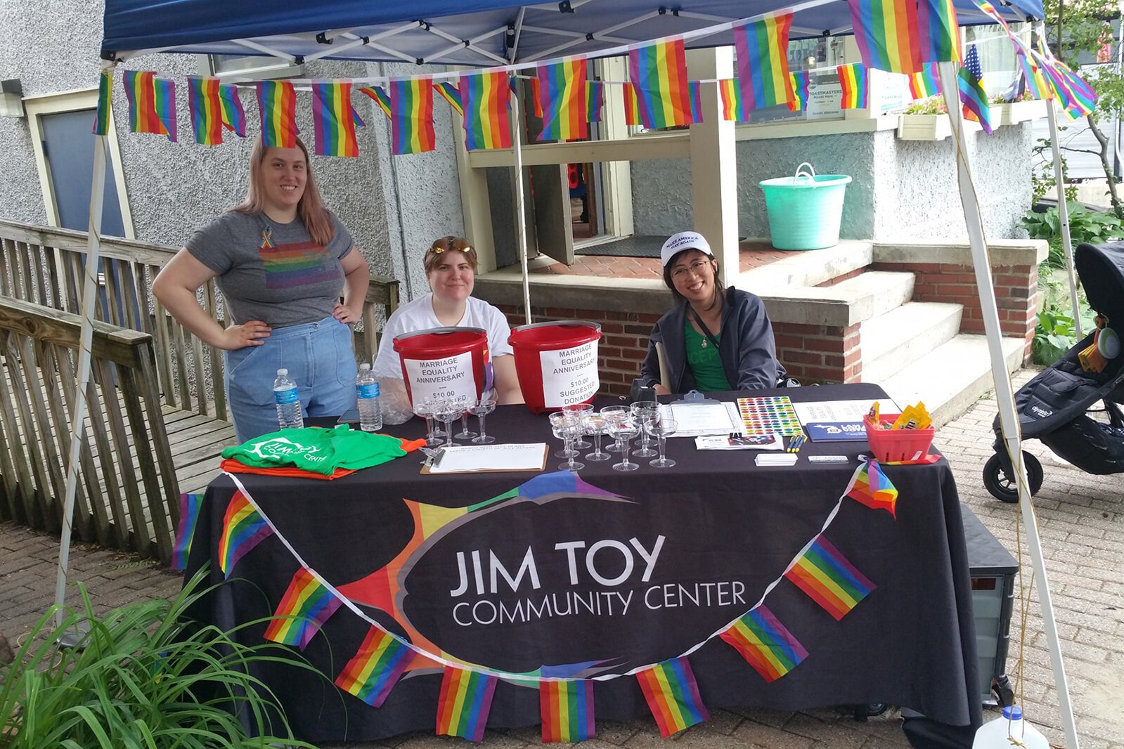 Staff work a booth outside the Jim Toy Community Center's office.