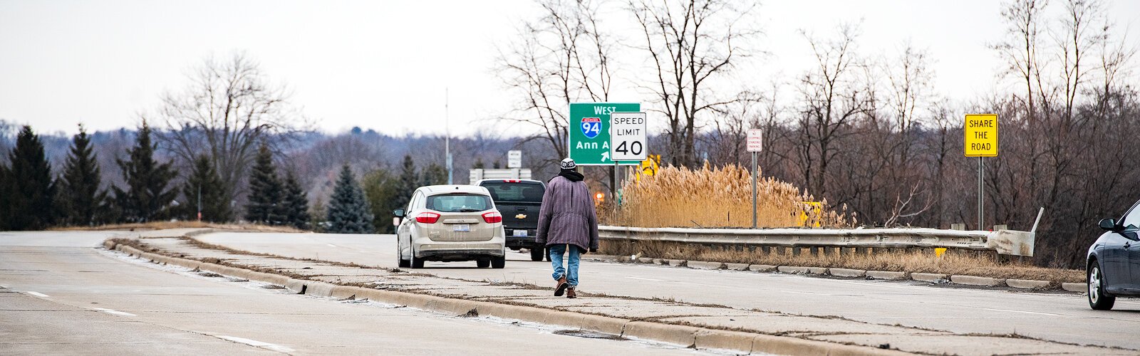 Qunitez Tomlin uses the Huron Street median to cross I-94.