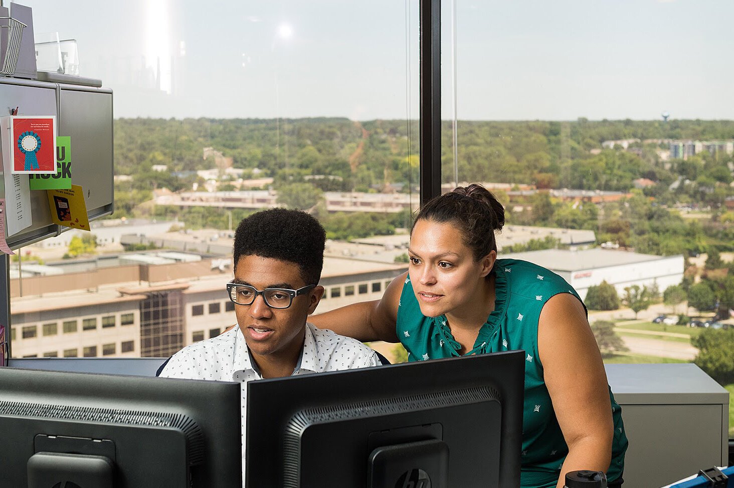 A past SummerWorks participant works with a supervisor.