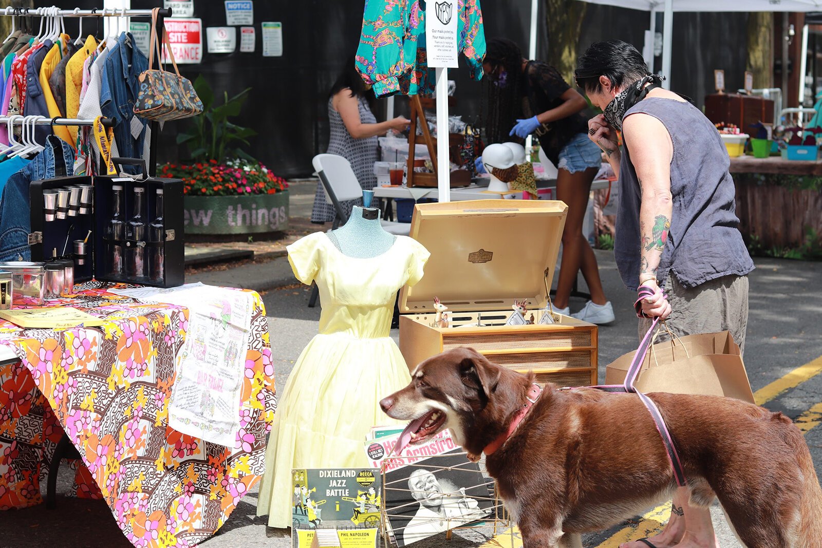 A customer browses a pop-up market hosted by The Back Office Studio.