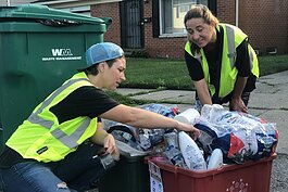 WRRMA-trained cart inspectors Laurena Deak and Julie Cline examine recycling bins in Ypsilanti Township.