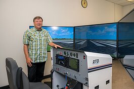 EMU aviation program coordinator Jerard Delaney with a new flight simulator.
