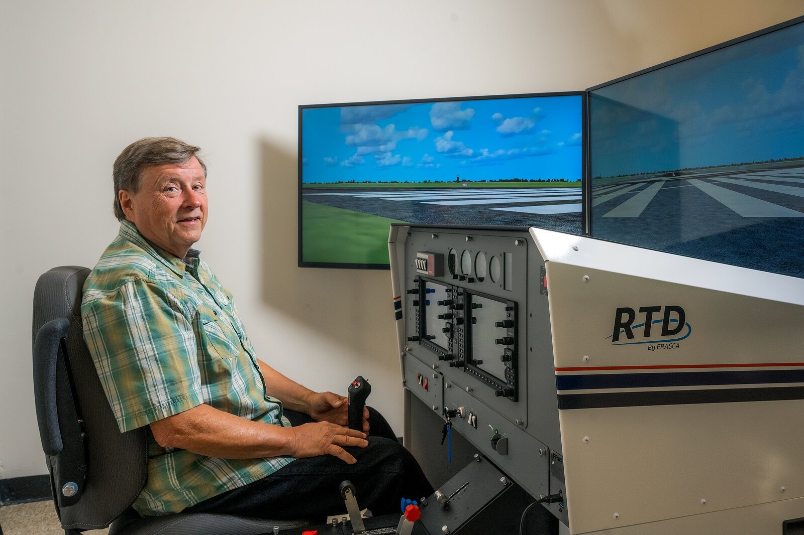 EMU aviation program coordinator Jerard Delaney with a new flight simulator.