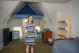 MOSAIC residence live-in program manager Anna DiGiovanni in a bedroom furninshed by HouseN2Home.