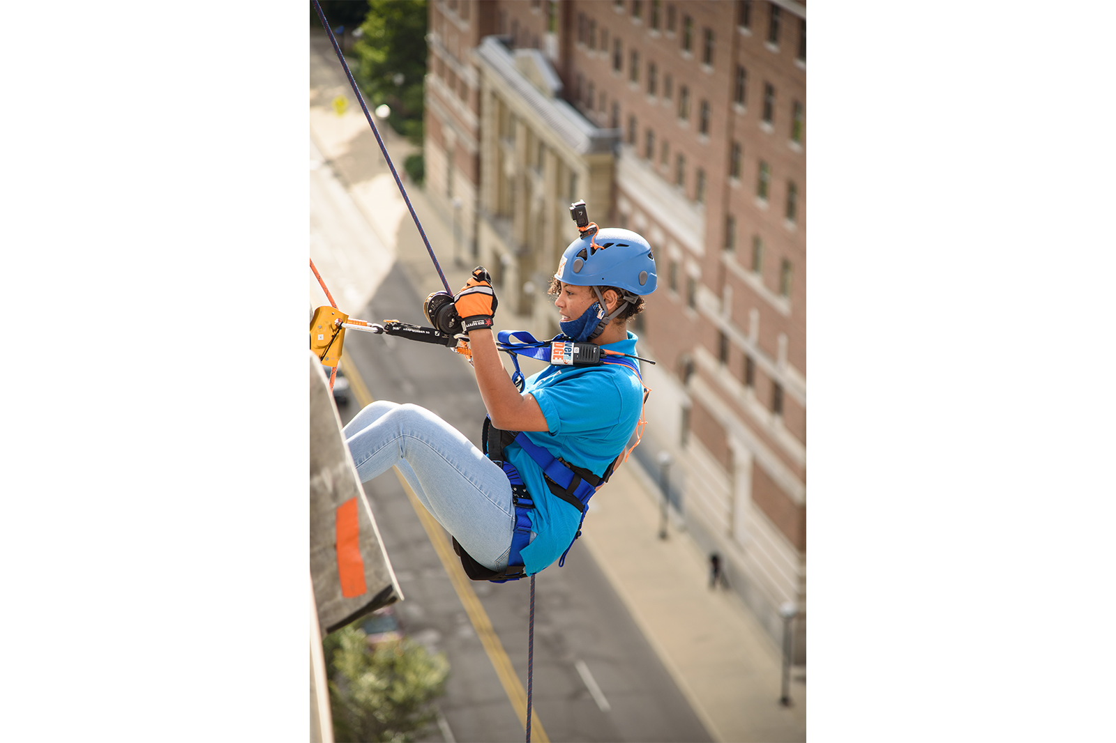 A participant at last year's Over the Edge event rappels down the Graduate Hotel.