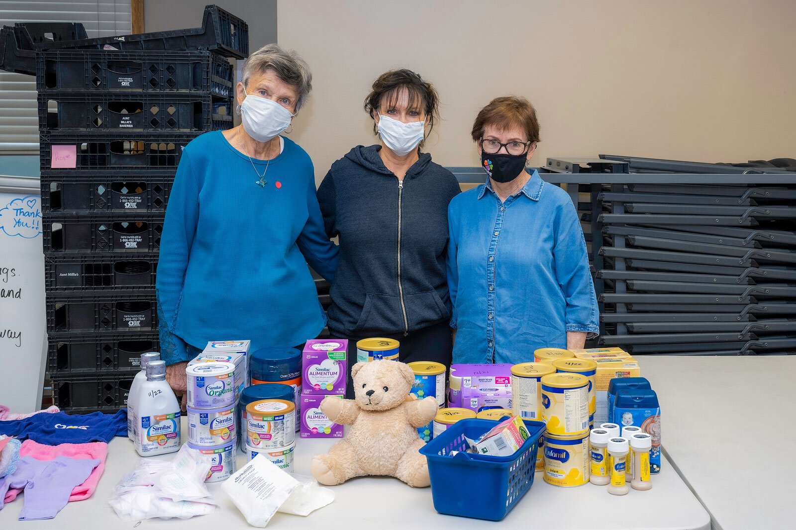 Ann VanZomeren, Shirley Perish, and Kathleen Mitchiner giving out baby care items at Hope Clinic.