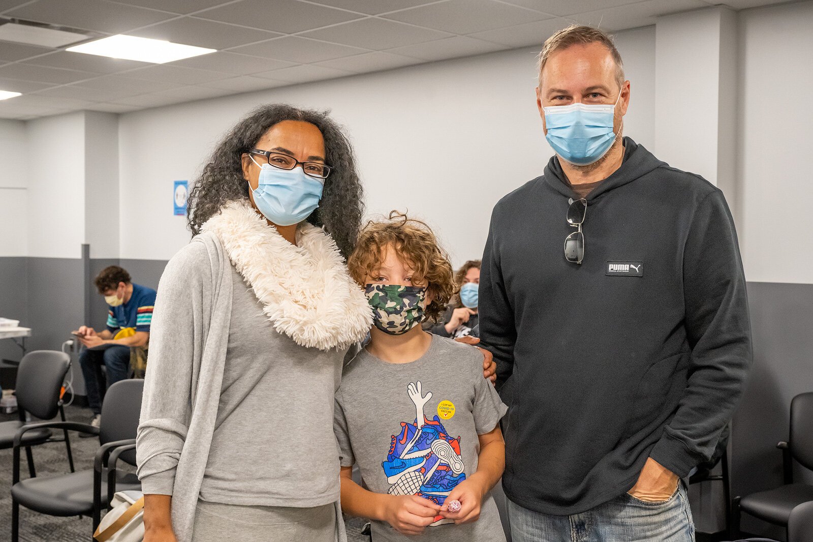 Pierre Boisseron-Kamp (center) after receiving his first vaccine shot at the WCHD with his parents Benedictte Boisseron and Ulrich Kamp.