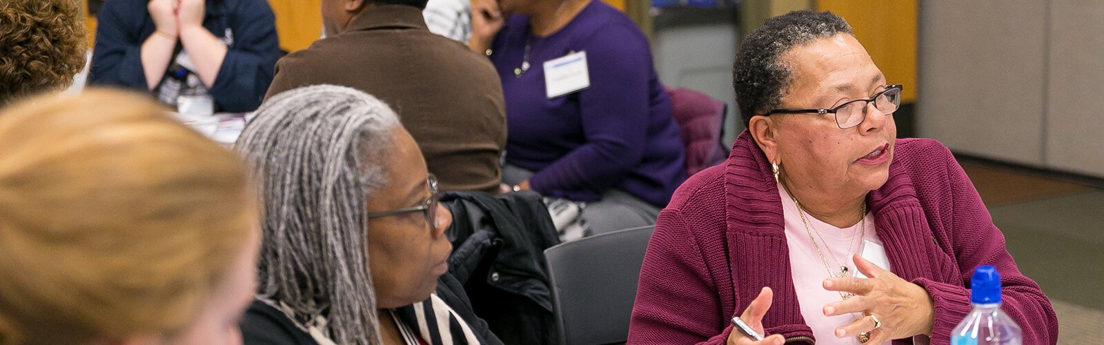 Sharon Moore (right) speaks at a 2019 Washtenaw Health Initiative stakeholders meeting.