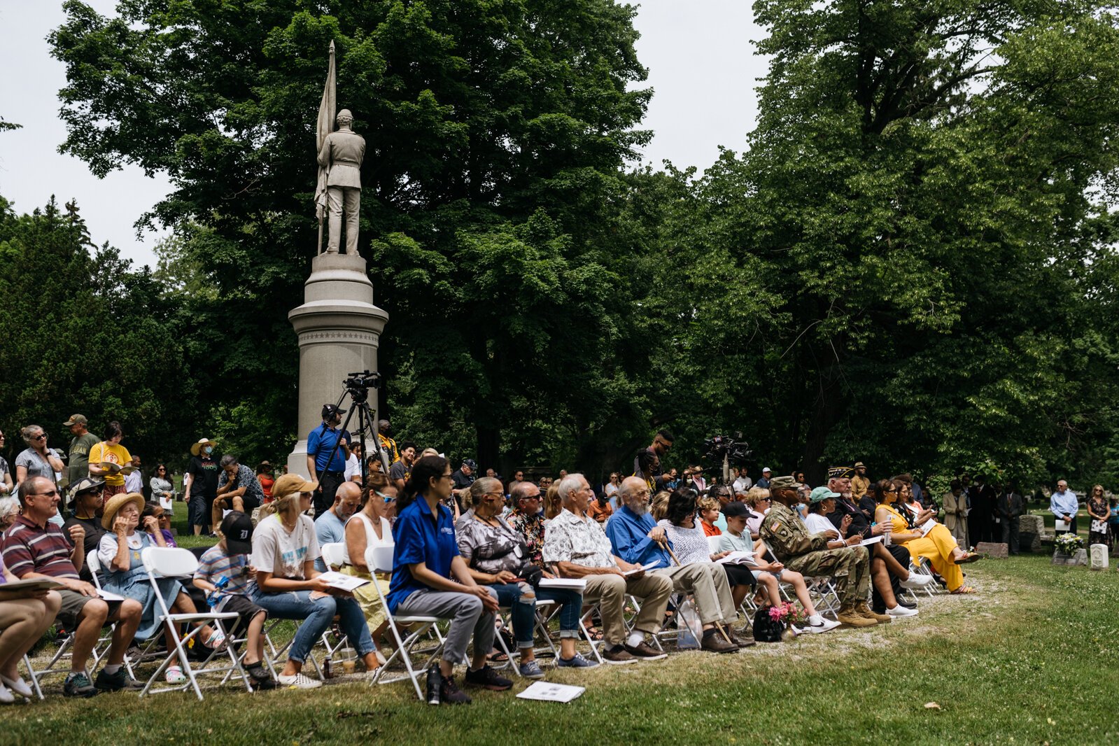 Attendees watch the unveiling ceremony for the monument.