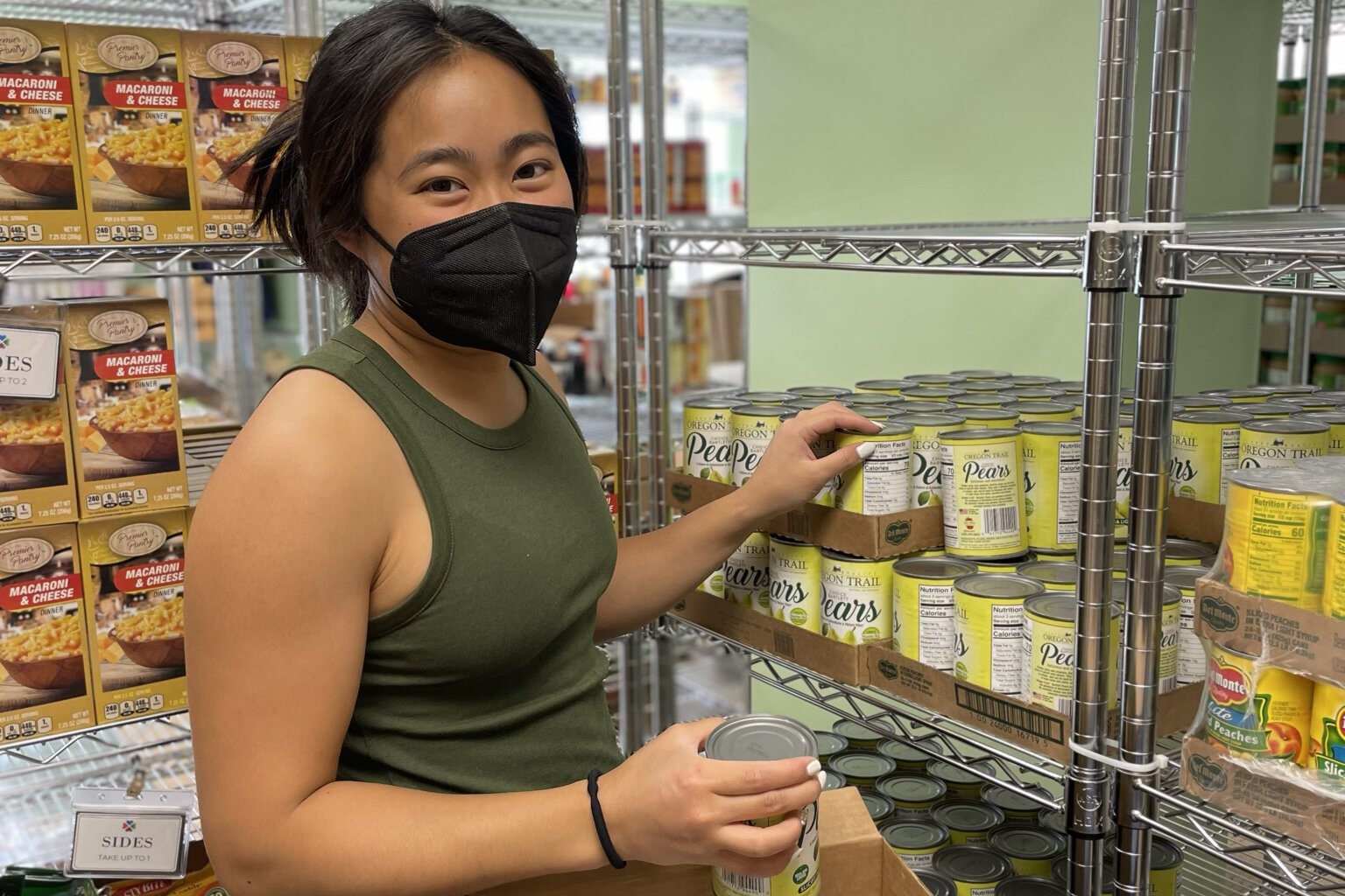 A volunteer stocks the food pantry at Hope Clinic.