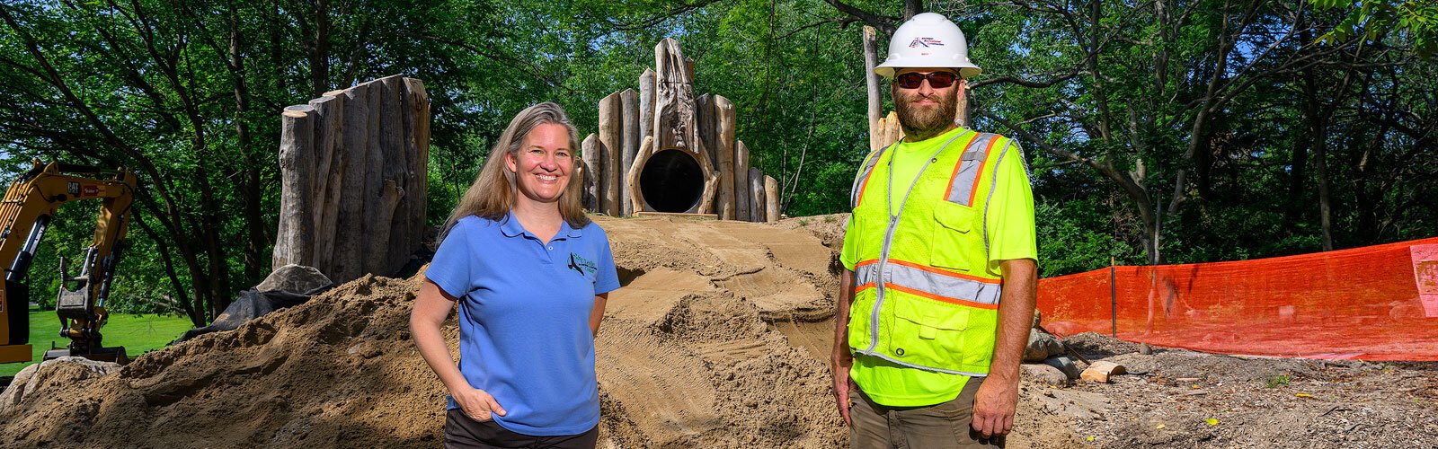 LSNC executive director Susan Westhoff and Michigan Recreational Construction's Mark Carscadden by the Nature Playscape.