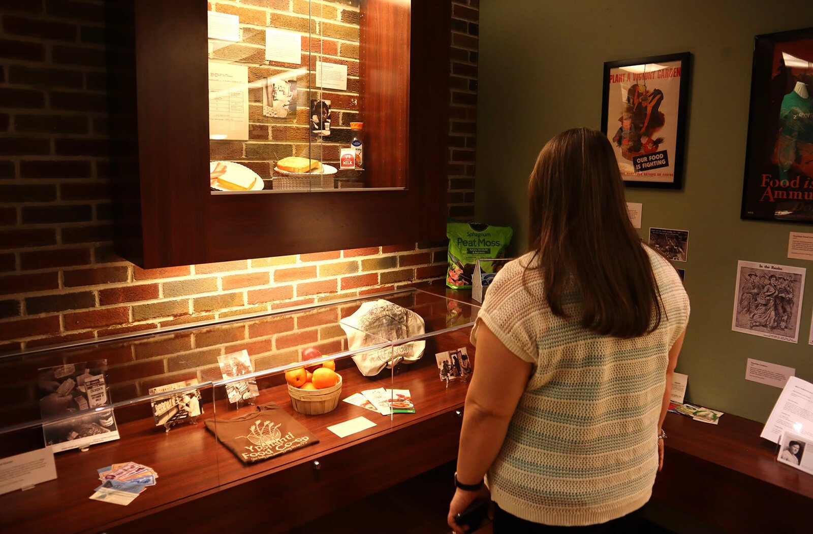 A visitor views the "Hamburgers for Breakfast" exhibit at the McKenny Gallery.