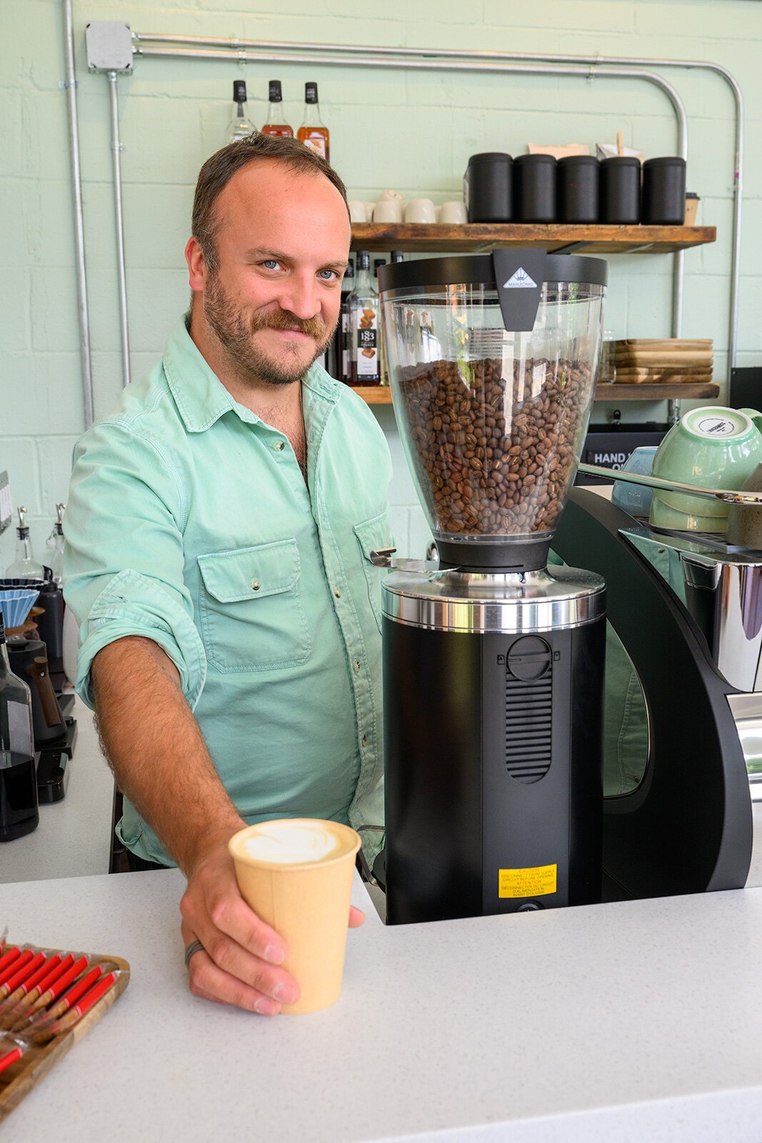 Scott Stevenson serving a latte at Cafe Liv.