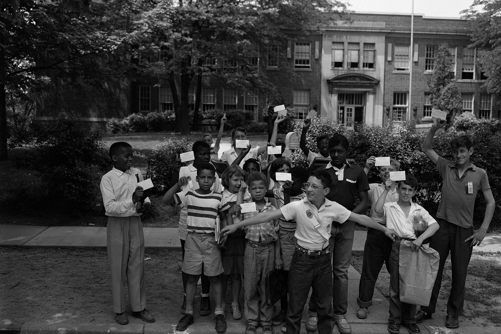 Jones School students hold up their report cards.